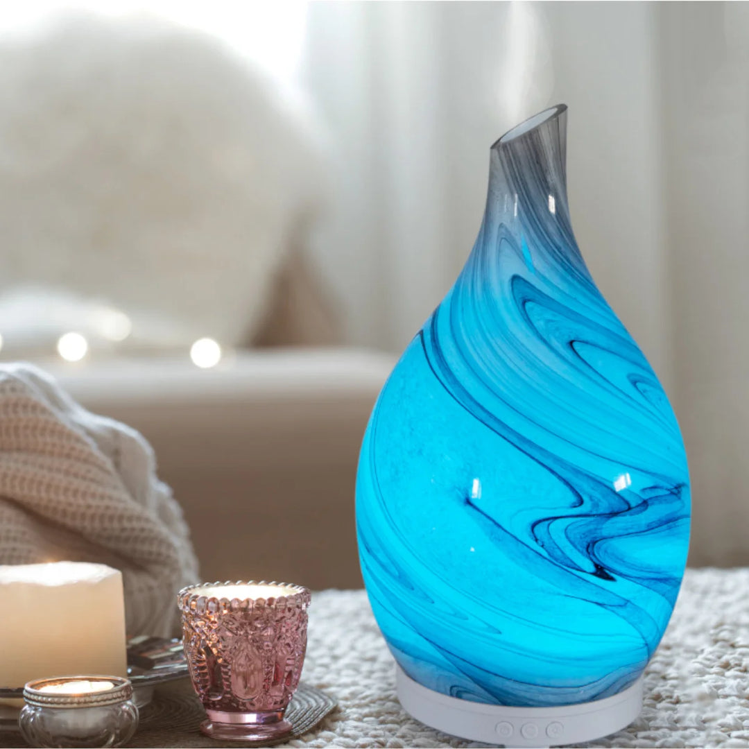 Elegant marble-effect glass electric diffuser with grey and white design. 