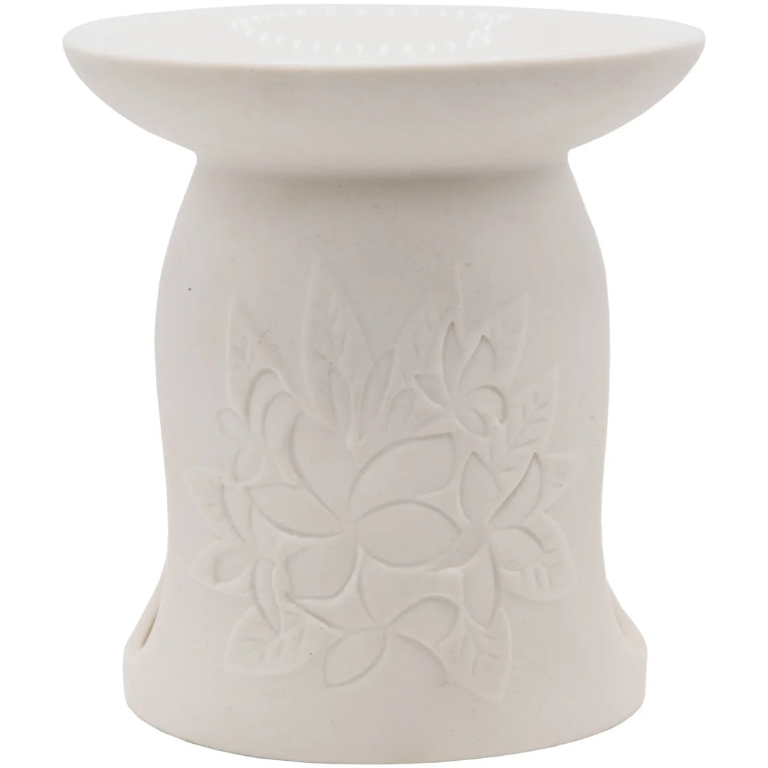 White ceramic wax warmer with delicate floral design. 
