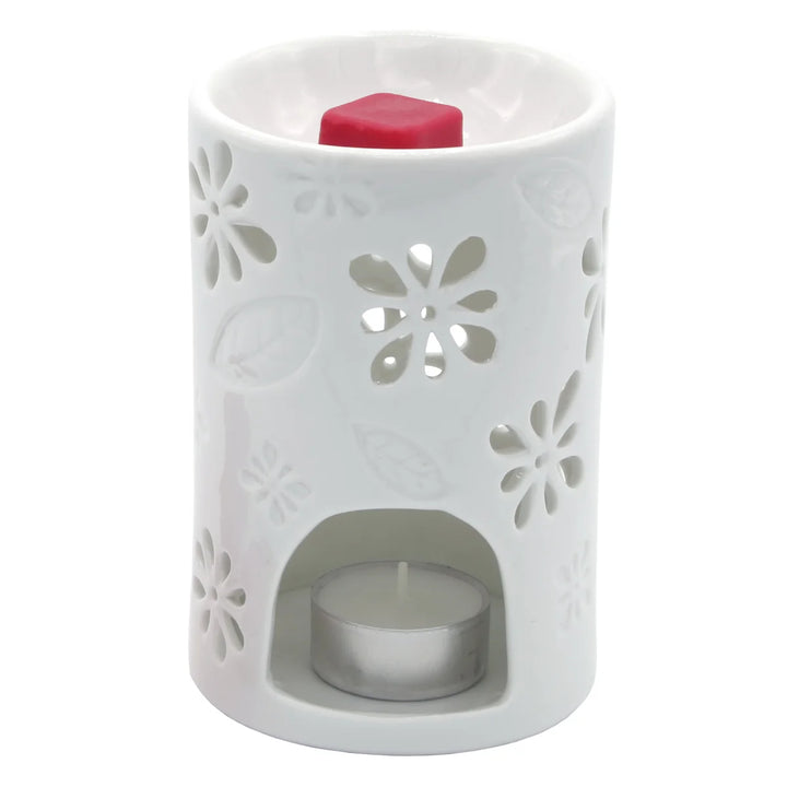 White ceramic wax warmer with delicate floral and leaf cut-out design. 