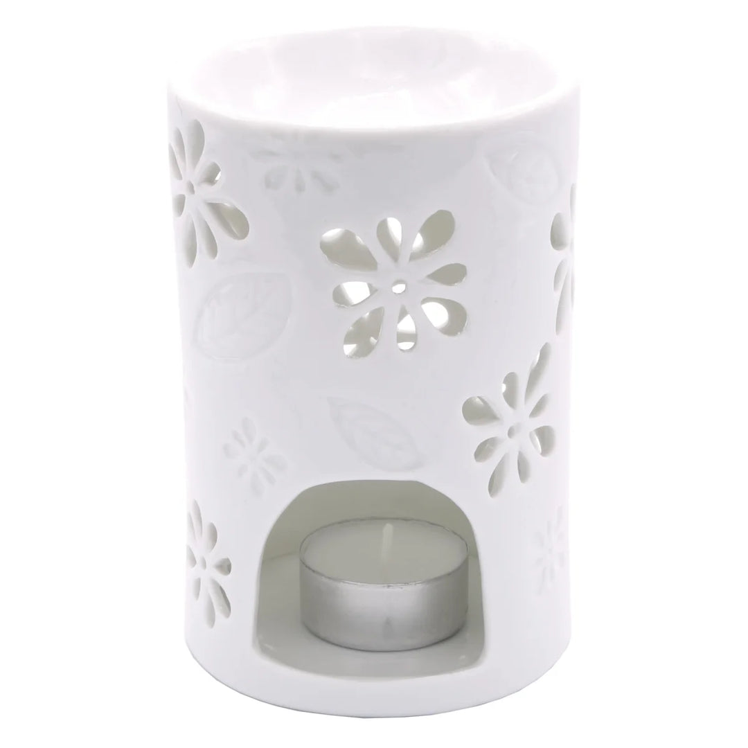 White ceramic wax warmer with delicate floral and leaf cut-out design. 