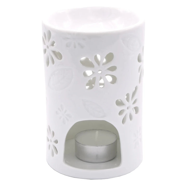 White ceramic wax warmer with delicate floral and leaf cut-out design. 