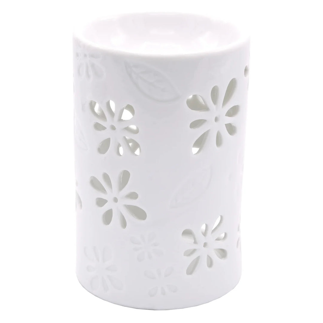 White ceramic wax warmer with delicate floral and leaf cut-out design. 
