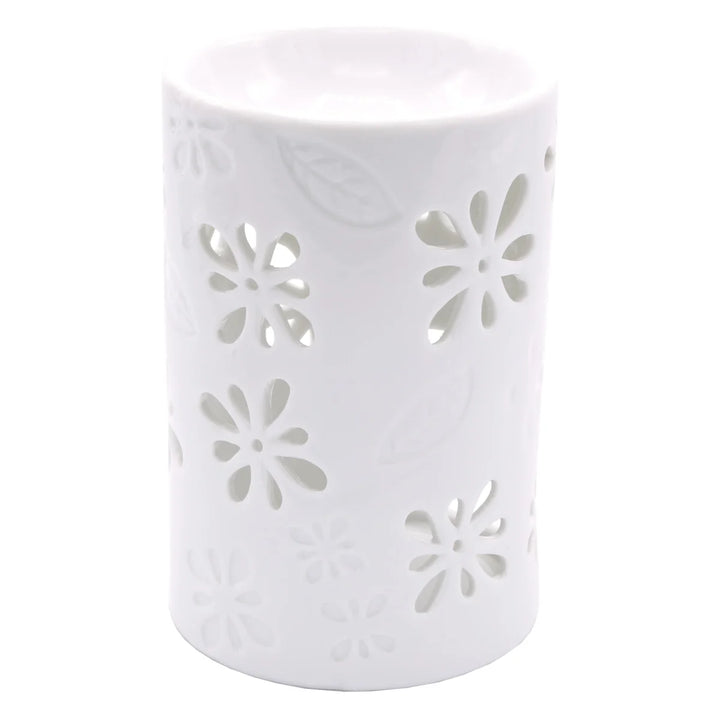 White ceramic wax warmer with delicate floral and leaf cut-out design. 