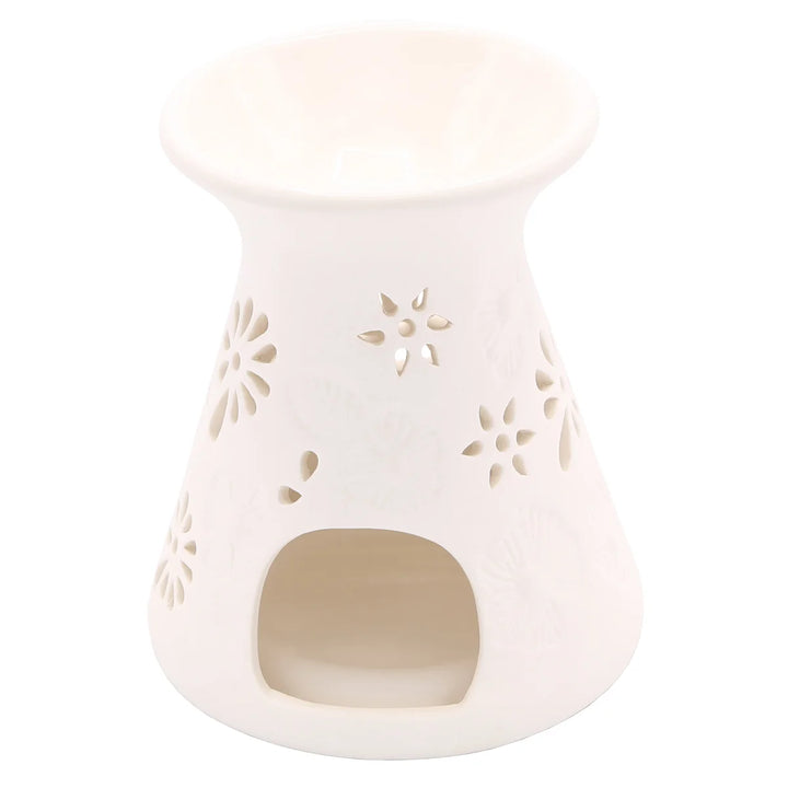 White ceramic wax warmer with delicate floral and leaf cut-out design. 
