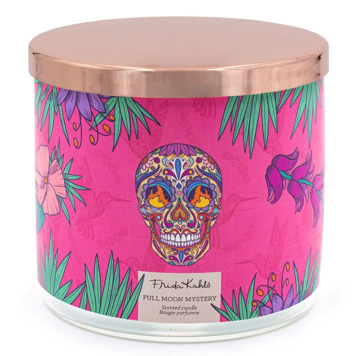 Frida Kahlo “Full Moon Mystery” scented candle with three wicks, featuring a vibrant pink label decorated with tropical leaves, flowers, and a colorful sugar-skull design.