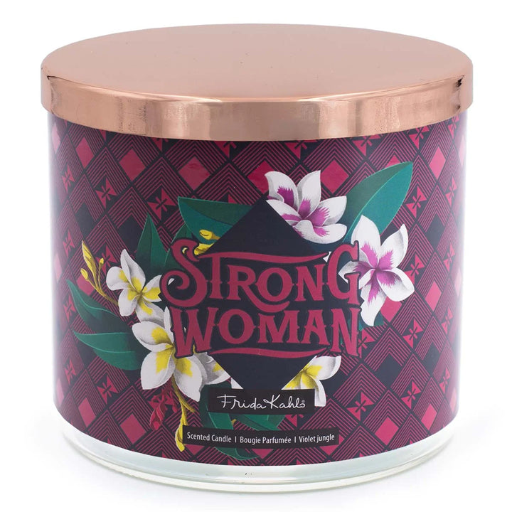 Frida Kahlo “Strong Woman” scented candle with rose-gold lid and bold burgundy geometric label featuring tropical flowers. 