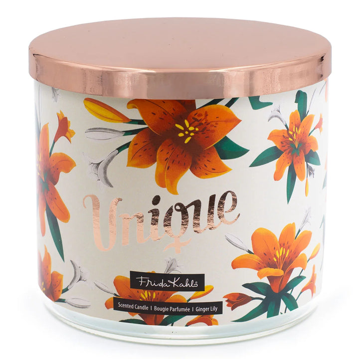 Frida Kahlo “Unique” scented candle with a rose-gold lid and floral ginger lily design. Decorative premium candle featuring vibrant orange lilies, perfect for home fragrance, gifting, and stylish interior décor.