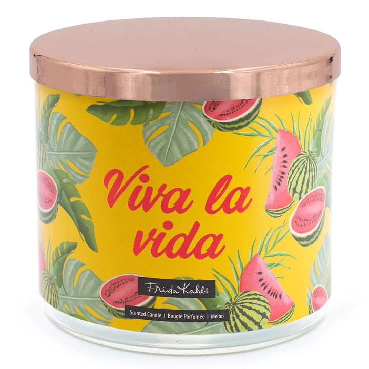Frida Kahlo “Viva la Vida” scented candle with rose-gold lid and vibrant yellow label featuring watermelon and tropical leaf illustrations. 