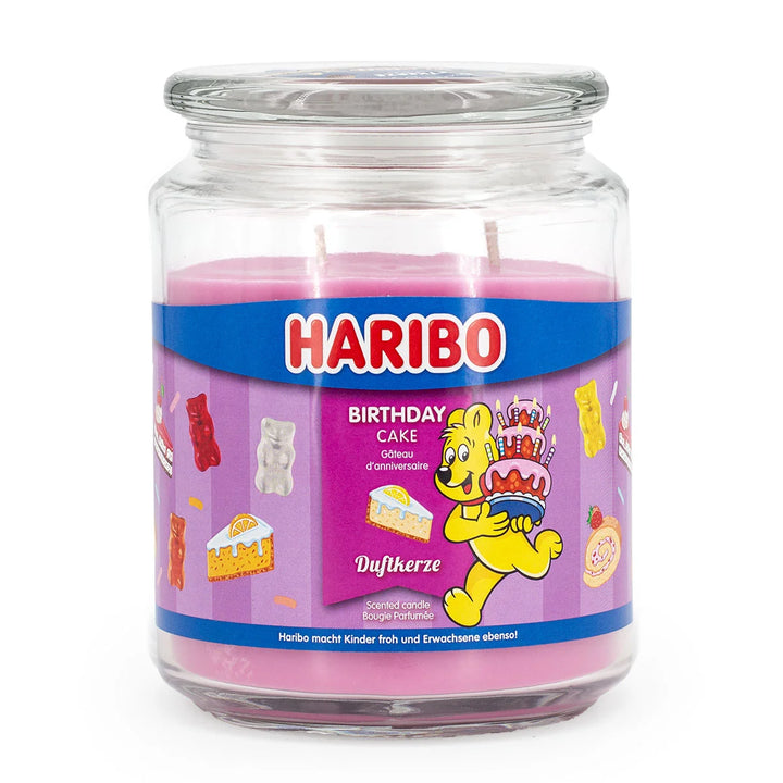 HARIBO Birthday Cake scented candle – pink jar candle decorated with cakes, gummy bears, and the cheerful HARIBO bear holding a birthday cake.