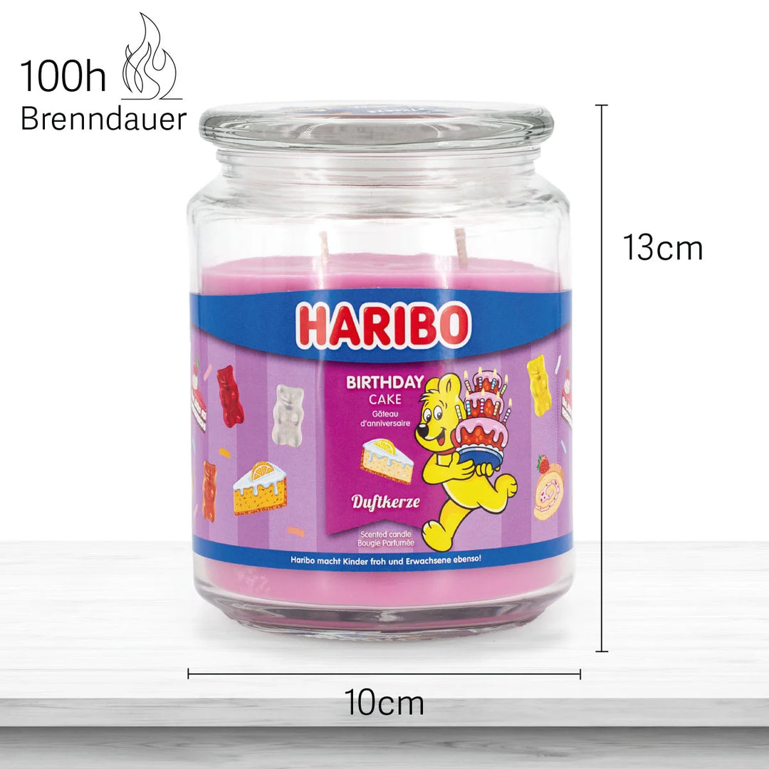 HARIBO Birthday Cake scented candle – pink jar candle decorated with cakes, gummy bears, and the cheerful HARIBO bear holding a birthday cake.