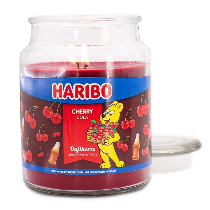Haribo Cherry Cola Scented Candle in glass jar with lit wick, red wax and cherries and cola design label