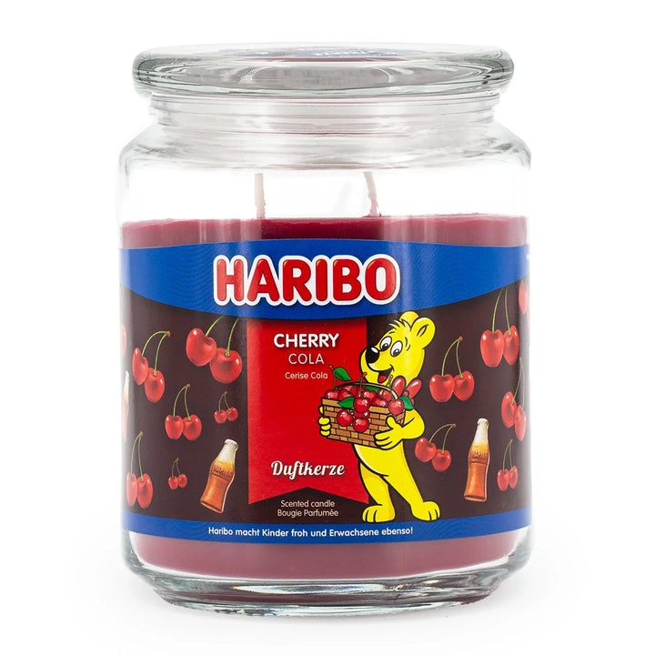 Haribo Cherry Cola Scented Candle in glass jar with lit wick, red wax and cherries and cola design label