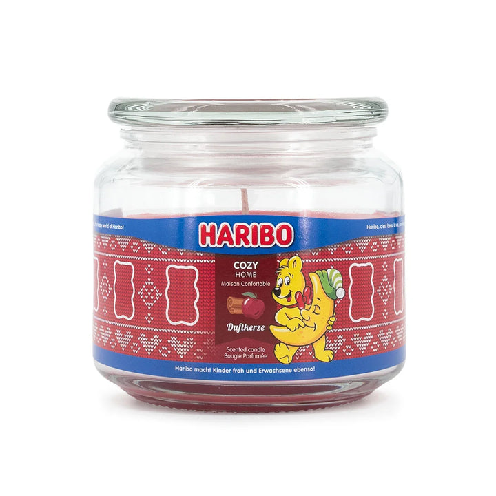 HARIBO Cozy Home scented candle – red jar candle decorated with apple, cinnamon, and the cheerful HARIBO bear holding a moon.