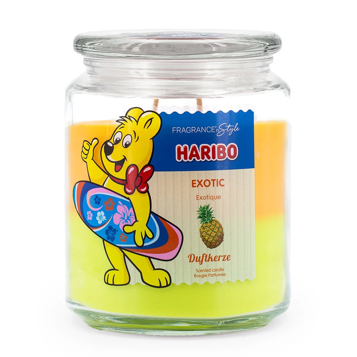HARIBO Exotic scented candle in a glass jar with orange and yellow wax featuring the Haribo bear holding a 
surf board