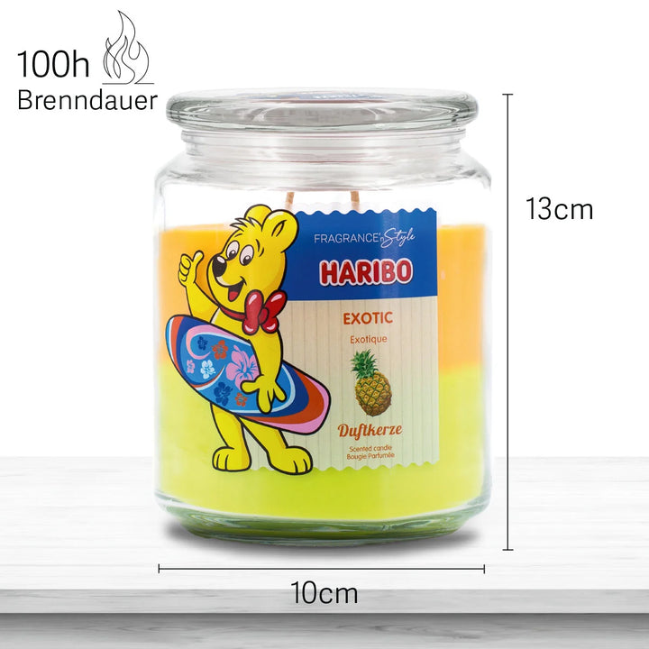 HARIBO Exotic scented candle in a glass jar with orange and yellow wax featuring the Haribo bear holding a 
surf board