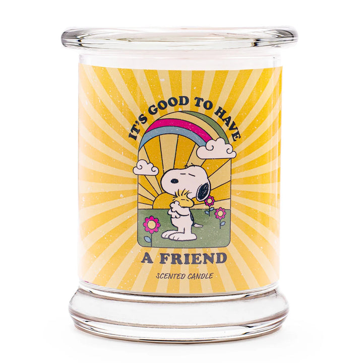 Peanuts A Friend Scented Candle  in glass jar with cotton wick and yellow design label with snoopy 