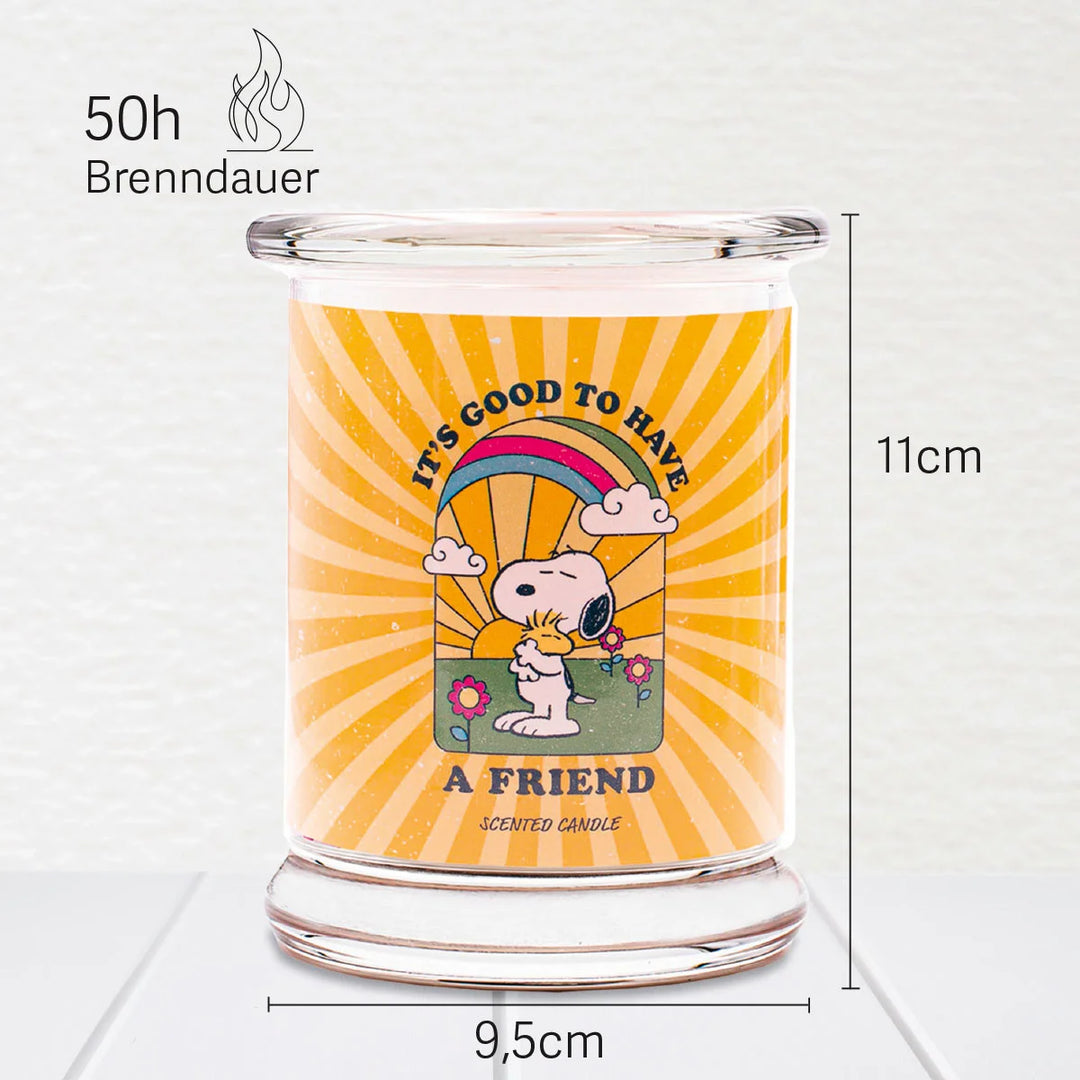 Peanuts A Friend Scented Candle  in glass jar with cotton wick and yellow design label with snoopy 